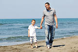 happy father and son have fun and enjoy time on beach