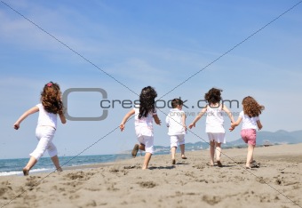 happy child group playing  on beach