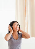 charming woman with closed eyes and earphones