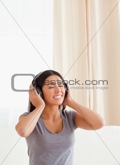 charming woman with closed eyes and earphones