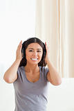 smiling woman with earphones looking into camera