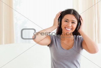 happy woman with earphones looking into camera