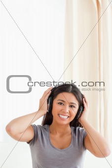 cute woman with earphones looking into camera