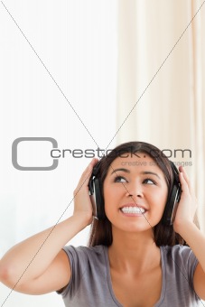 cute woman with earphones looking up