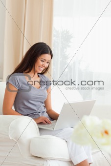 working woman sitting on sofa with notebook