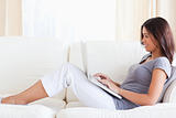 smiling woman on sofa with notebook