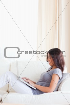 dark-haired woman sitting on sofa 