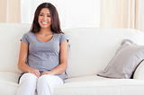 Smiling Woman sitting on a sofa