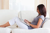 charming woman on sofa with notebook