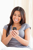 cheerful woman looking at mobile phone