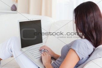 dark-haired woman working on notebook