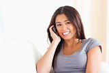 brunette woman phoning looking into camera
