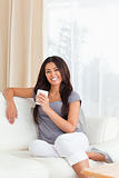 smiling woman with cup looking into camera