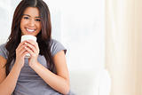 smiling woman holding a cup