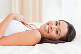 close up of a charming woman lying on bed
