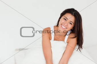charming woman sitting in bed 