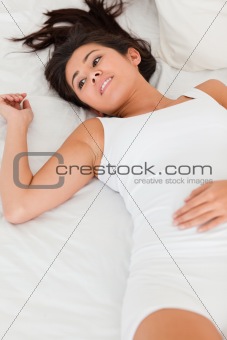 relaxing smiling woman lying on bed