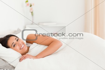 relaxing woman lying under sheet
