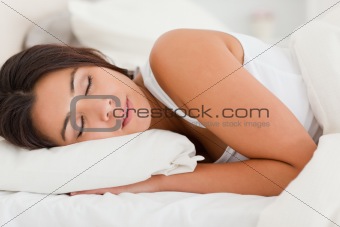 close up of a sleeping gorgeous woman lying under sheet