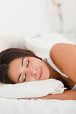 close up of a sleeping beautiful woman lying under sheet