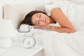 close up of a  cute woman sleeping under sheet 