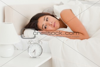 close up of a  cute woman waking under sheet 