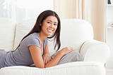 smiling woman lying on sofa