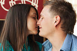 Love young couple kissing in cafe