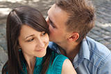 Love young couple kissing in the street