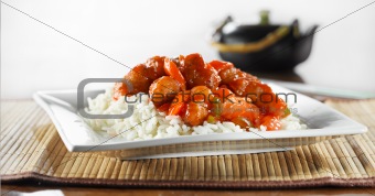 sweet and sour pork on rice wide shot