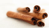 cinnamon sticks laying in a pile with selective focus