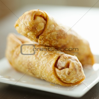 two egg rolls stacked on top of each other