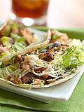 two soft shell chicken tacos