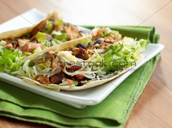 two soft shell chicken tacos