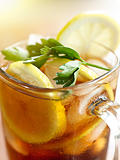 iced tea with lemon slice and leaf garnish.