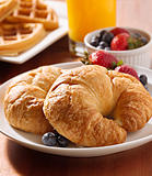 breakfast with two croissants and berries.