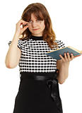 Young beautiful woman in glasses with a book