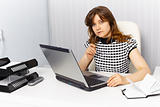Secretary working in office with laptop