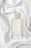 White perfume bottle on the silk.