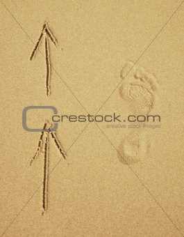 Trace of a human foot on sand. Tourist traffic.