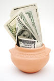 dollars in ceramic pot