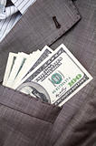 dollars in the pocket of business suit