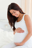 Portrait of an attractive pregnant woman touching her belly 
