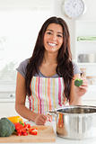 Attractive woman preparing vegetables while standing