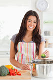 Charming woman preparing vegetables while standing