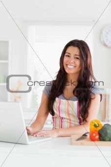Attractive woman relaxing with her laptop while standing