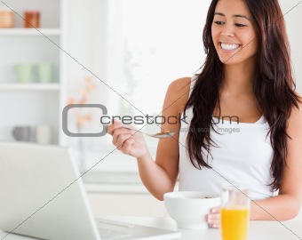 Beautiful woman enjoying a bowl of cereals while relaxing 