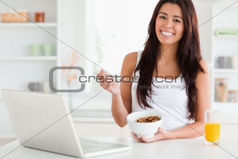 Attractive woman enjoying a bowl of cereals while relaxing
