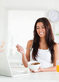 Good looking woman enjoying a bowl of cereals while relaxing