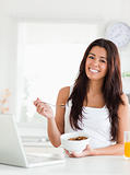 Gorgeous woman enjoying a bowl of cereals while relaxing 